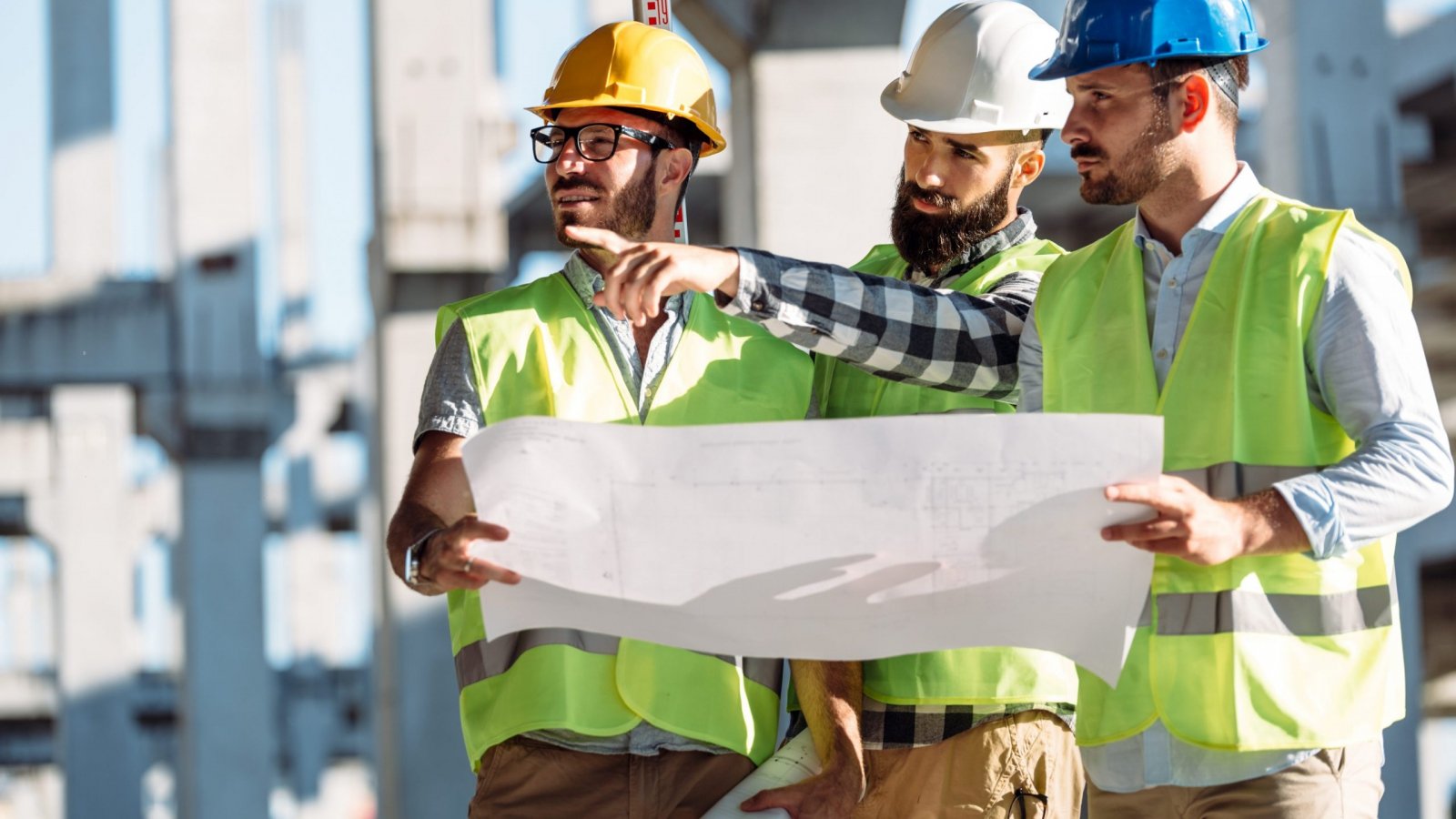 Portrait of construction engineers working on building site together